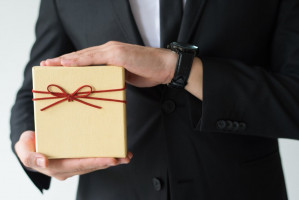 close up man with wristwatch holding gift box 1262 17806